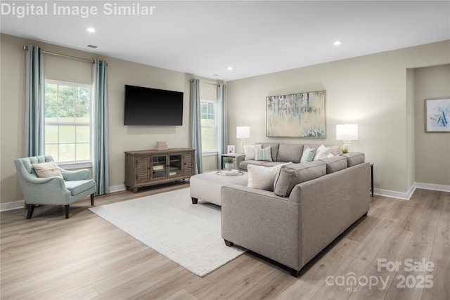 living area featuring recessed lighting, a wealth of natural light, and light wood finished floors