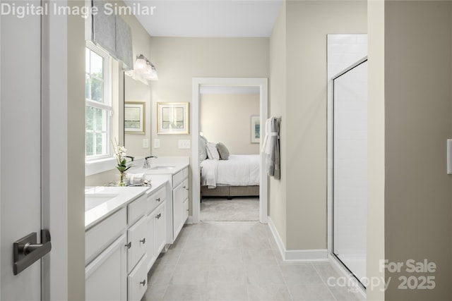 ensuite bathroom featuring double vanity, a shower stall, a sink, and ensuite bathroom