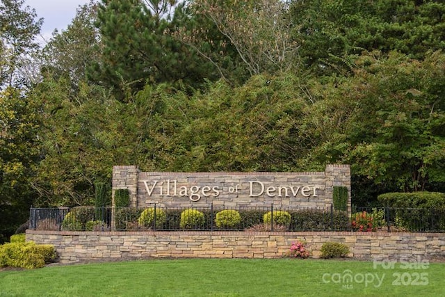 community / neighborhood sign featuring a lawn