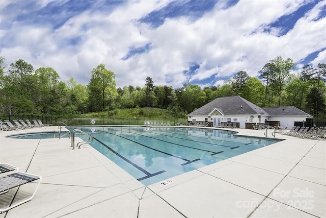 pool with fence and a patio area