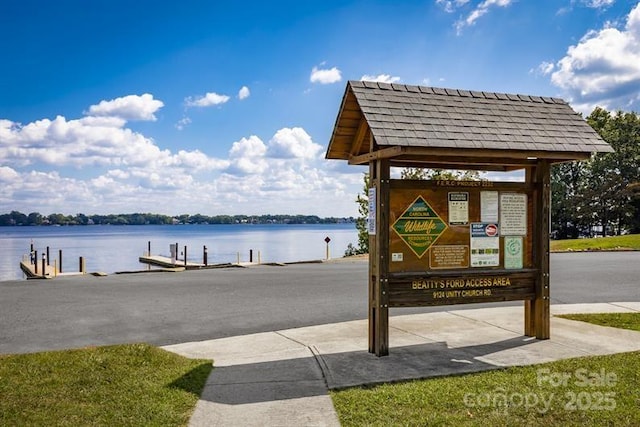view of home's community with a boat dock and a water view