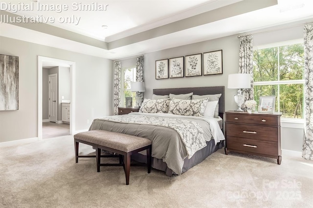 bedroom featuring baseboards, light colored carpet, visible vents, and ensuite bath