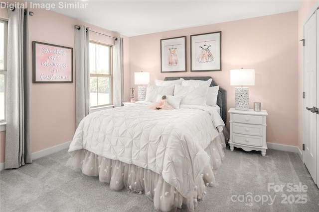 bedroom featuring baseboards and light carpet