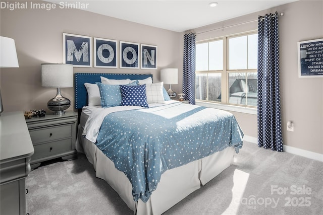 carpeted bedroom featuring baseboards