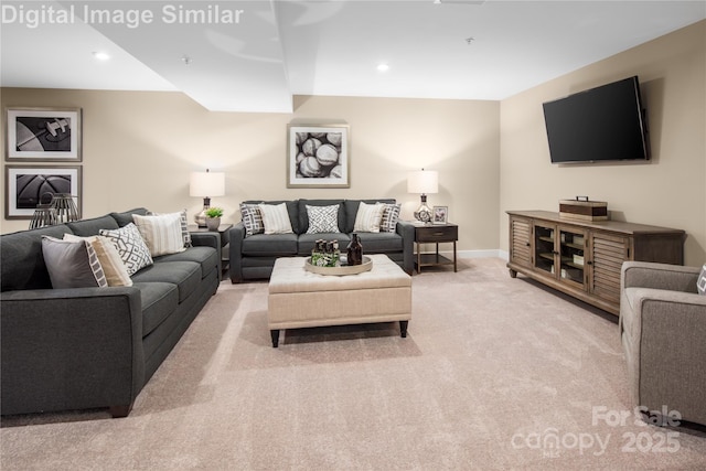 carpeted living room featuring baseboards and recessed lighting
