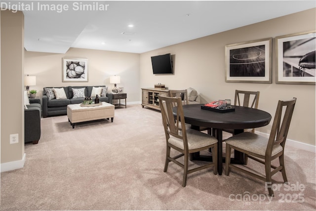 carpeted dining area featuring baseboards