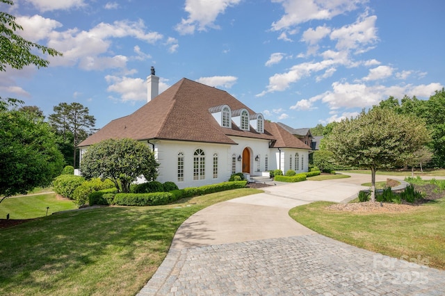 5400 Challisford Ln, Charlotte, NC 28226 - french country inspired facade with a shingled roof, stucco siding, a front yard, a chimney, and curved driveway