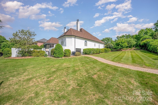 5400 Challisford Ln, Charlotte, NC 28226 - back of house with stucco siding, a sunroom, central AC unit, a chimney, and a lawn