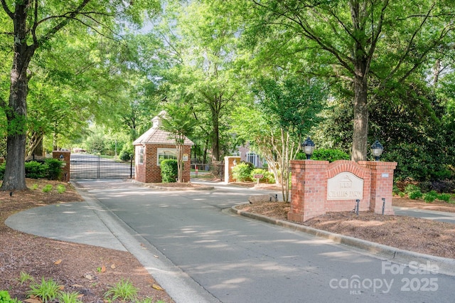 5400 Challisford Ln, Charlotte, NC 28226 - view of street featuring a gate, a gated entry, curbs, and street lighting