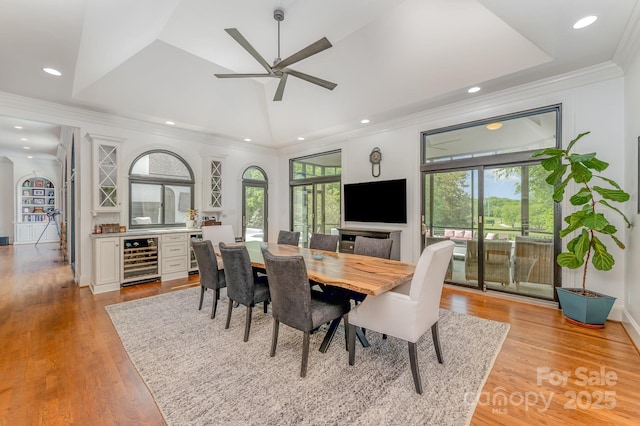 5400 Challisford Ln, Charlotte, NC 28226 - dining room featuring wine cooler, a ceiling fan, a bar, ornamental molding, and light wood finished floors