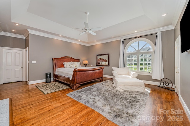 5400 Challisford Ln, Charlotte, NC 28226 - bedroom featuring a tray ceiling, wood finished floors, baseboards, crown molding, and recessed lighting