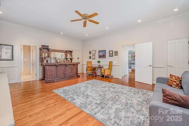 5400 Challisford Ln, Charlotte, NC 28226 - living room featuring ornamental molding, a bar, ceiling fan, and wood finished floors