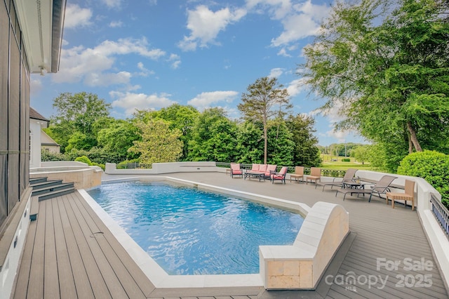 5400 Challisford Ln, Charlotte, NC 28226 - outdoor pool featuring a wooden deck, view of wooded area, a patio, and an outdoor hangout area
