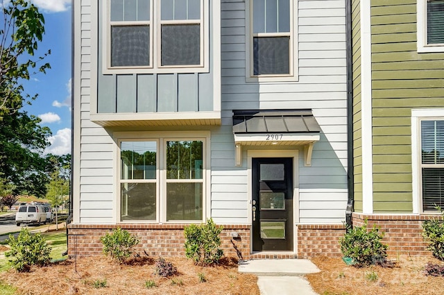 2907 W Trade St, Charlotte, NC 28208 - entrance to property featuring brick siding and board and batten siding