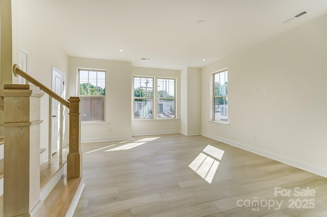 2907 W Trade St, Charlotte, NC 28208 - unfurnished living room with light wood finished floors, baseboards, and recessed lighting