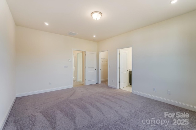 2907 W Trade St, Charlotte, NC 28208 - unfurnished bedroom featuring recessed lighting, baseboards, visible vents, a spacious closet, and light colored carpet