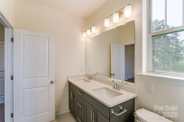 2907 W Trade St, Charlotte, NC 28208 - bathroom with toilet, a wealth of natural light, and a sink