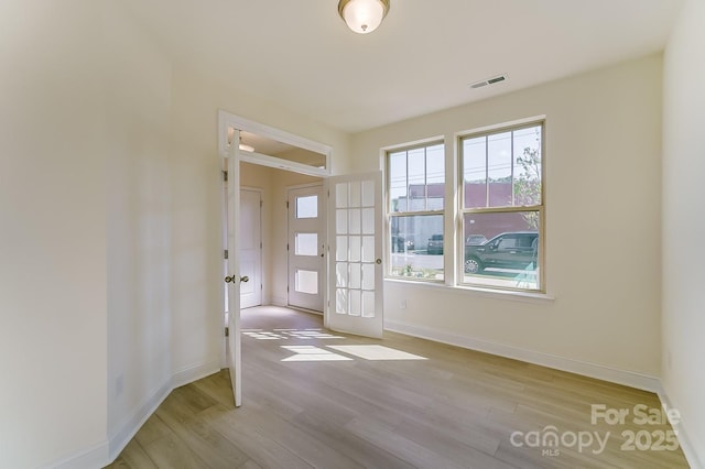 2907 W Trade St, Charlotte, NC 28208 - unfurnished room with baseboards, light wood finished floors, french doors, and visible vents