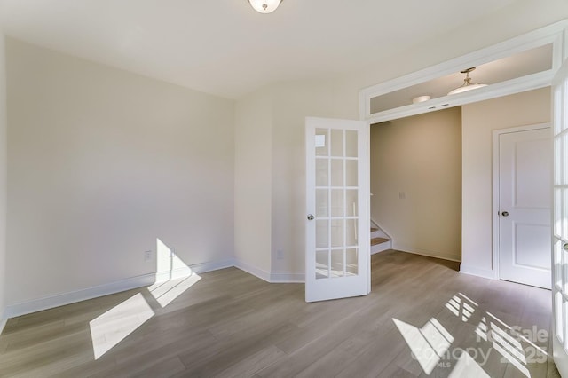 2907 W Trade St, Charlotte, NC 28208 - spare room featuring stairway, baseboards, and wood finished floors