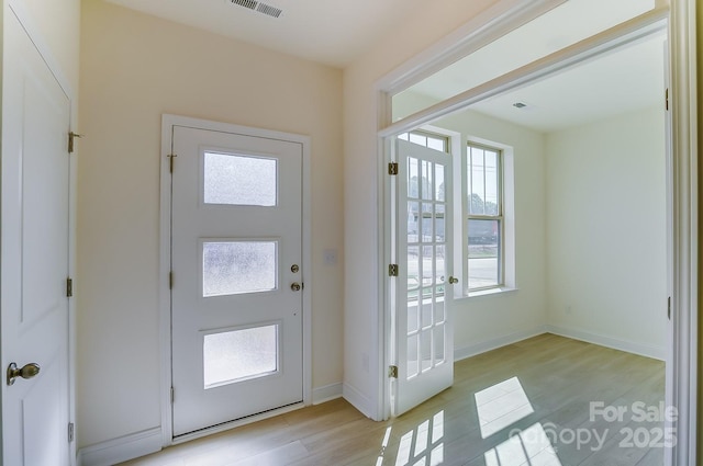 2907 W Trade St, Charlotte, NC 28208 - entrance foyer featuring baseboards, a healthy amount of sunlight, light wood-type flooring, and visible vents