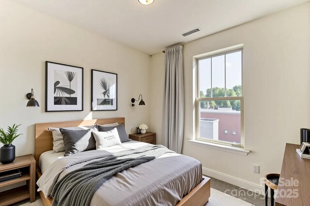 2907 W Trade St, Charlotte, NC 28208 - bedroom featuring baseboards, light carpet, and visible vents