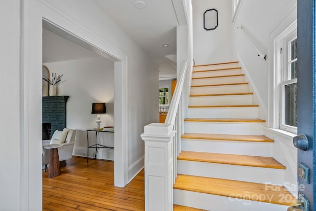 21 Sylvan Ave, Asheville, NC 28801 - stairs with wood-type flooring, a fireplace, and baseboards