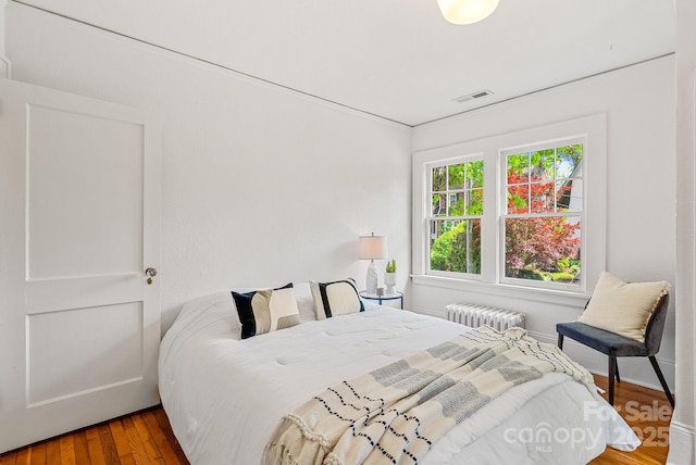 21 Sylvan Ave, Asheville, NC 28801 - bedroom with radiator heating unit and wood finished floors