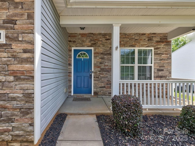 6541 Hasley Woods Dr, Huntersville, NC 28078 - view of exterior entry featuring a porch and stone siding