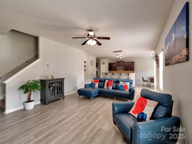 6541 Hasley Woods Dr, Huntersville, NC 28078 - living room with visible vents, light wood-style floors, baseboards, stairway, and a ceiling fan