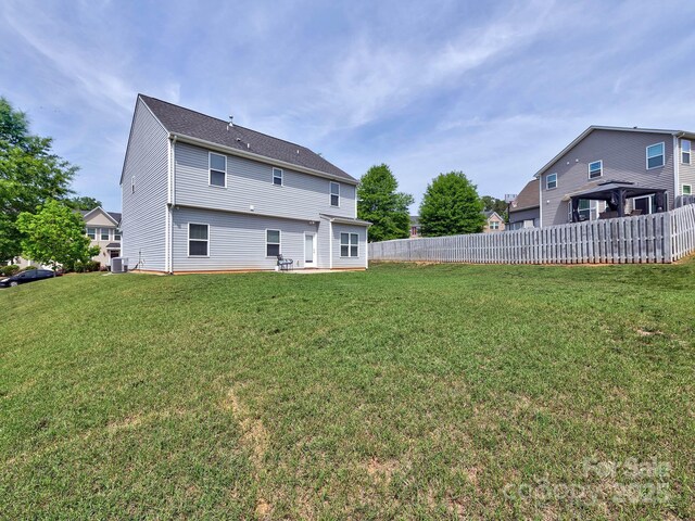 6541 Hasley Woods Dr, Huntersville, NC 28078 - back of property featuring fence, a lawn, and central AC
