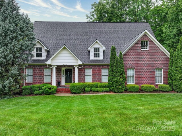 3015 Hamptonbrook Dr, Gastonia, NC 28056 - cape cod home with brick siding, a front yard, and roof with shingles