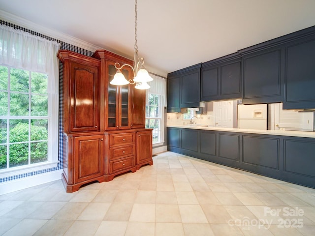 3015 Hamptonbrook Dr, Gastonia, NC 28056 - kitchen featuring a sink, light countertops, a chandelier, freestanding refrigerator, and plenty of natural light