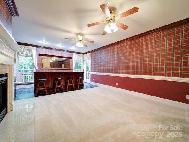 3015 Hamptonbrook Dr, Gastonia, NC 28056 - kitchen featuring ornamental molding, wallpapered walls, carpet flooring, baseboards, and a ceiling fan
