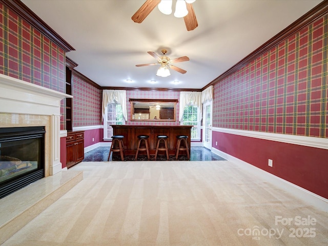 3015 Hamptonbrook Dr, Gastonia, NC 28056 - kitchen featuring wallpapered walls, ceiling fan, crown molding, baseboards, and carpet flooring