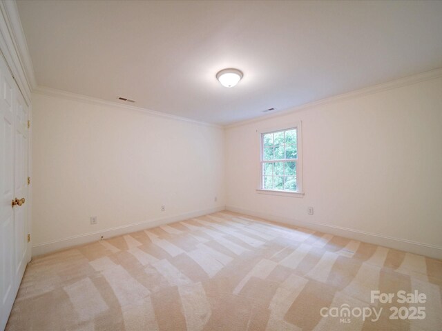 3015 Hamptonbrook Dr, Gastonia, NC 28056 - spare room featuring crown molding, baseboards, and light carpet