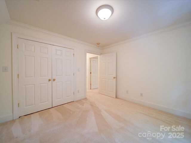 3015 Hamptonbrook Dr, Gastonia, NC 28056 - unfurnished bedroom featuring crown molding, carpet flooring, a closet, and baseboards