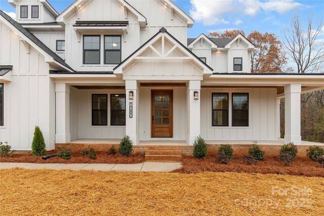 4095 Kingfisher Dr, York, SC 29745 - view of front of property with a standing seam roof, covered porch, board and batten siding, and metal roof