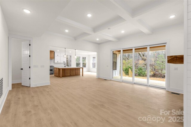 4095 Kingfisher Dr, York, SC 29745 - unfurnished living room with baseboards, light wood-style flooring, a healthy amount of sunlight, and coffered ceiling