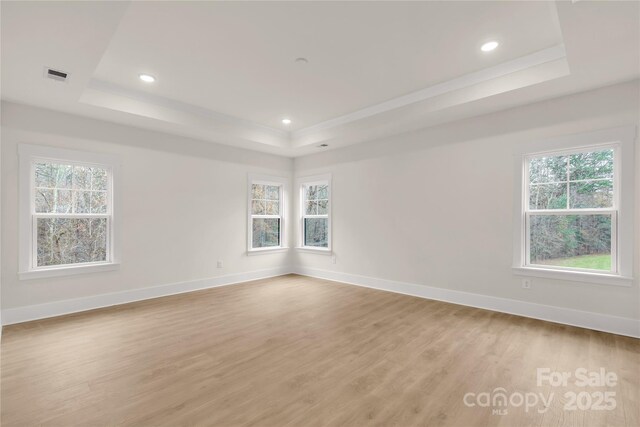 4095 Kingfisher Dr, York, SC 29745 - unfurnished room featuring visible vents, a raised ceiling, baseboards, light wood finished floors, and recessed lighting