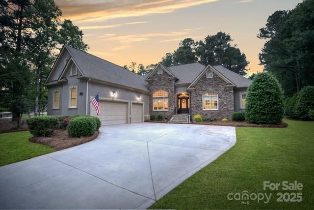 7687 Bermuda Hills Ln, Denver, NC 28037 - craftsman-style house featuring concrete driveway, stone siding, a lawn, and an attached garage