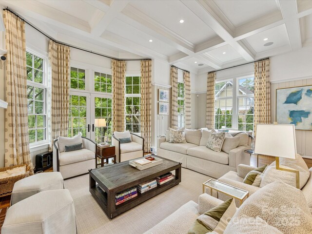living room with coffered ceiling, beamed ceiling, and healthy amount of natural light