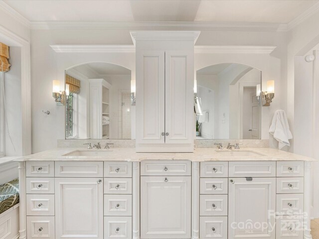 full bath with double vanity and crown molding