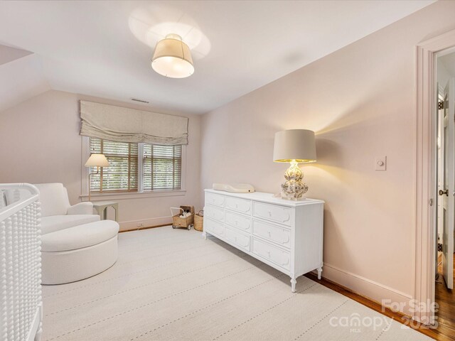 bedroom with baseboards and vaulted ceiling