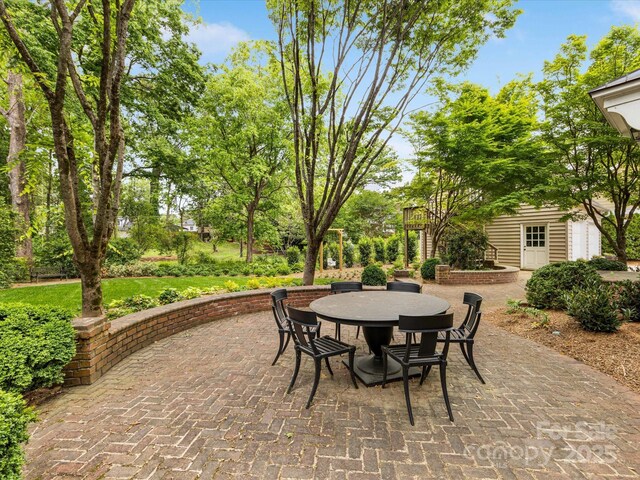 view of patio / terrace with outdoor dining area and an outdoor structure