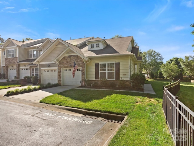 view of front of house featuring a garage, fence, a front lawn, concrete driveway, and stone siding