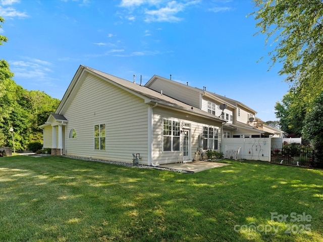 back of house with a patio area, fence, and a yard