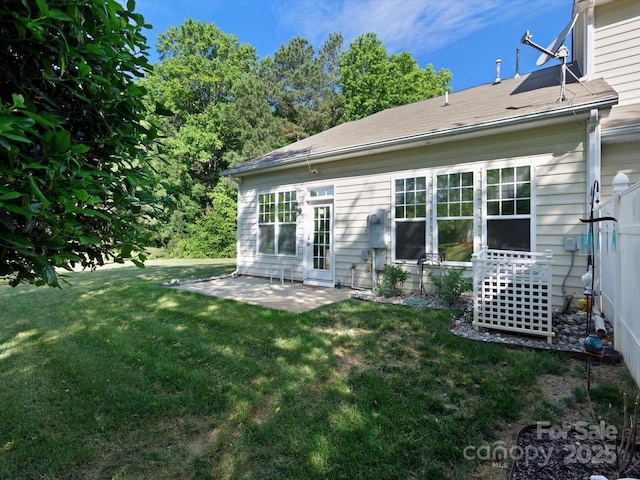 rear view of house with a lawn and a patio area