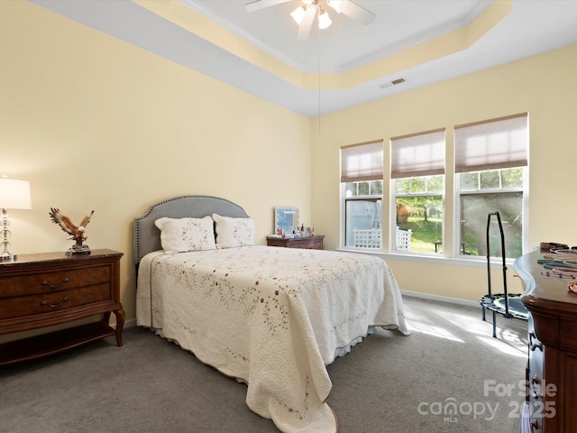 bedroom featuring carpet floors, ornamental molding, visible vents, baseboards, and a ceiling fan