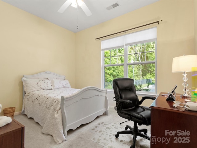 carpeted bedroom with baseboards, multiple windows, ceiling fan, and visible vents