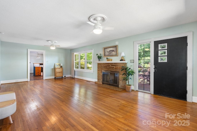 3418 Sulphur Springs Rd NE, Hickory, NC 28601 - unfurnished living room with a ceiling fan, wood finished floors, baseboards, and a textured ceiling